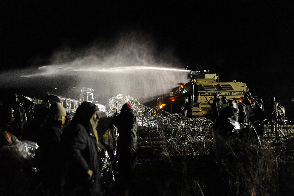 Police spray water protectors with fire hoses on Nov. 20, 2016 near Standing Rock.